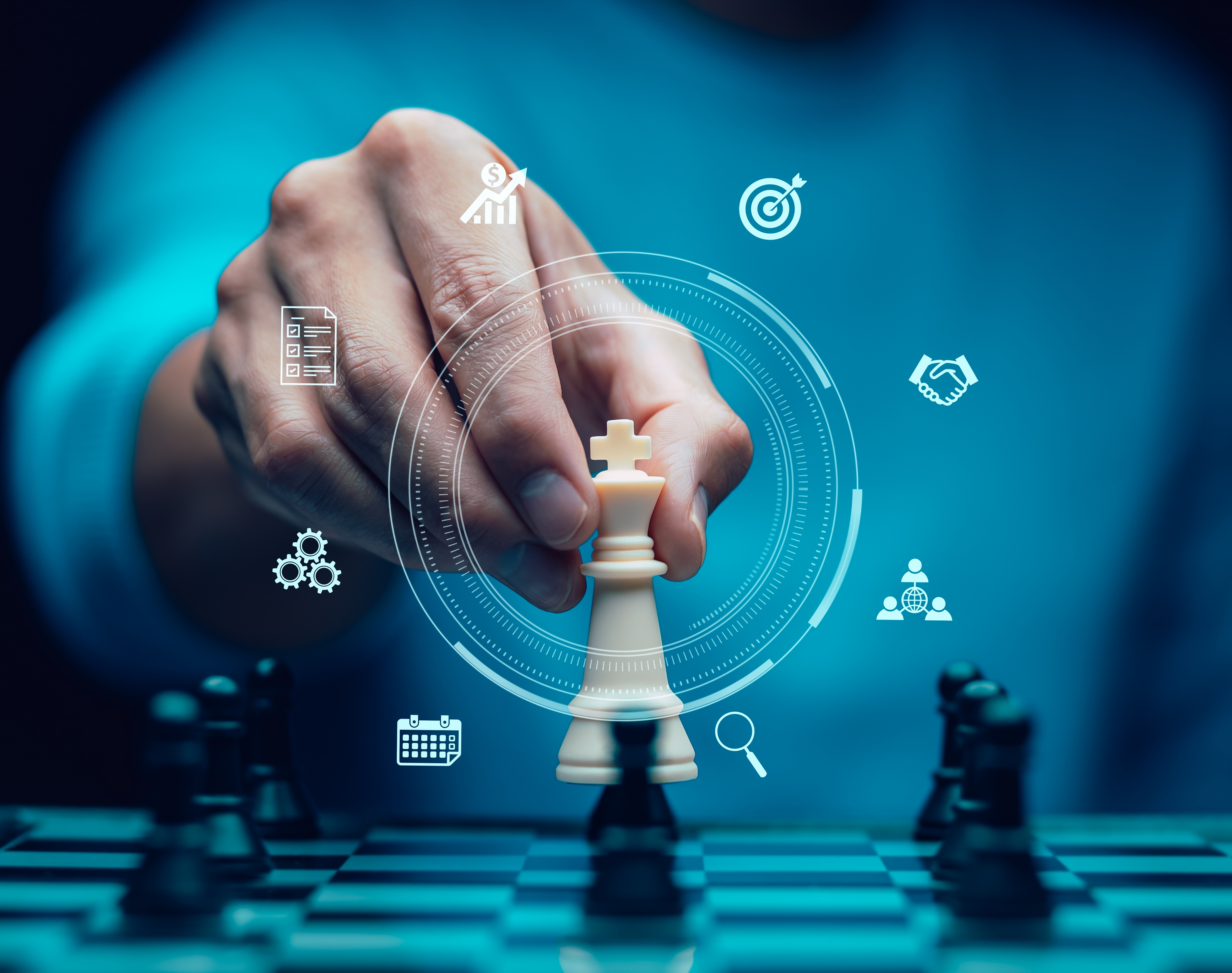 Hand moving a king chess piece symbolizing strategic business planning.
